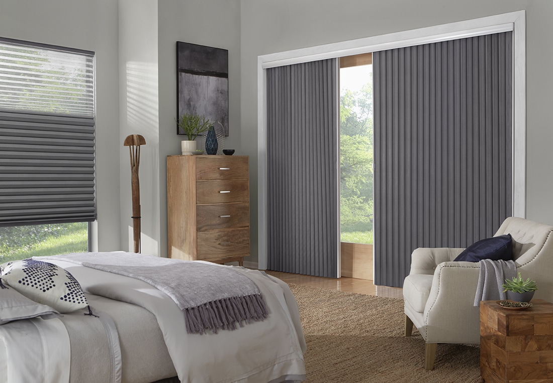 Vertical cellular shades on sliding patio door in modern bedroom