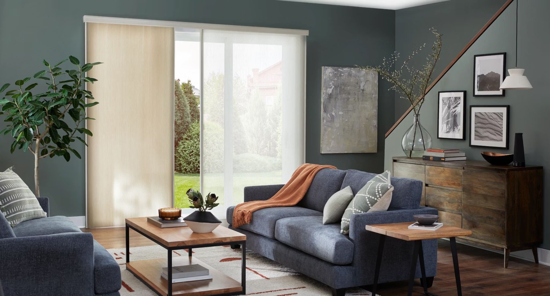 Vertical honeycomb shades on sliding glass door in green living room