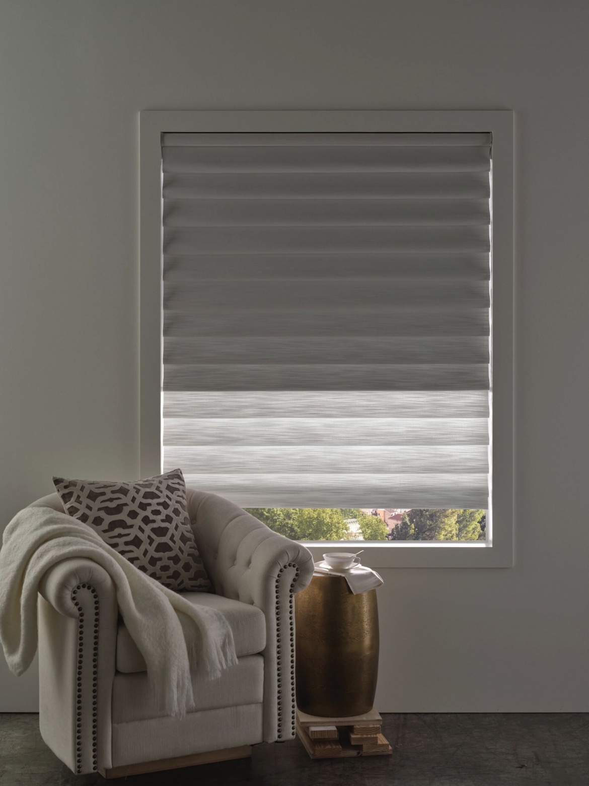 an arm chair in front of linen fabric shades