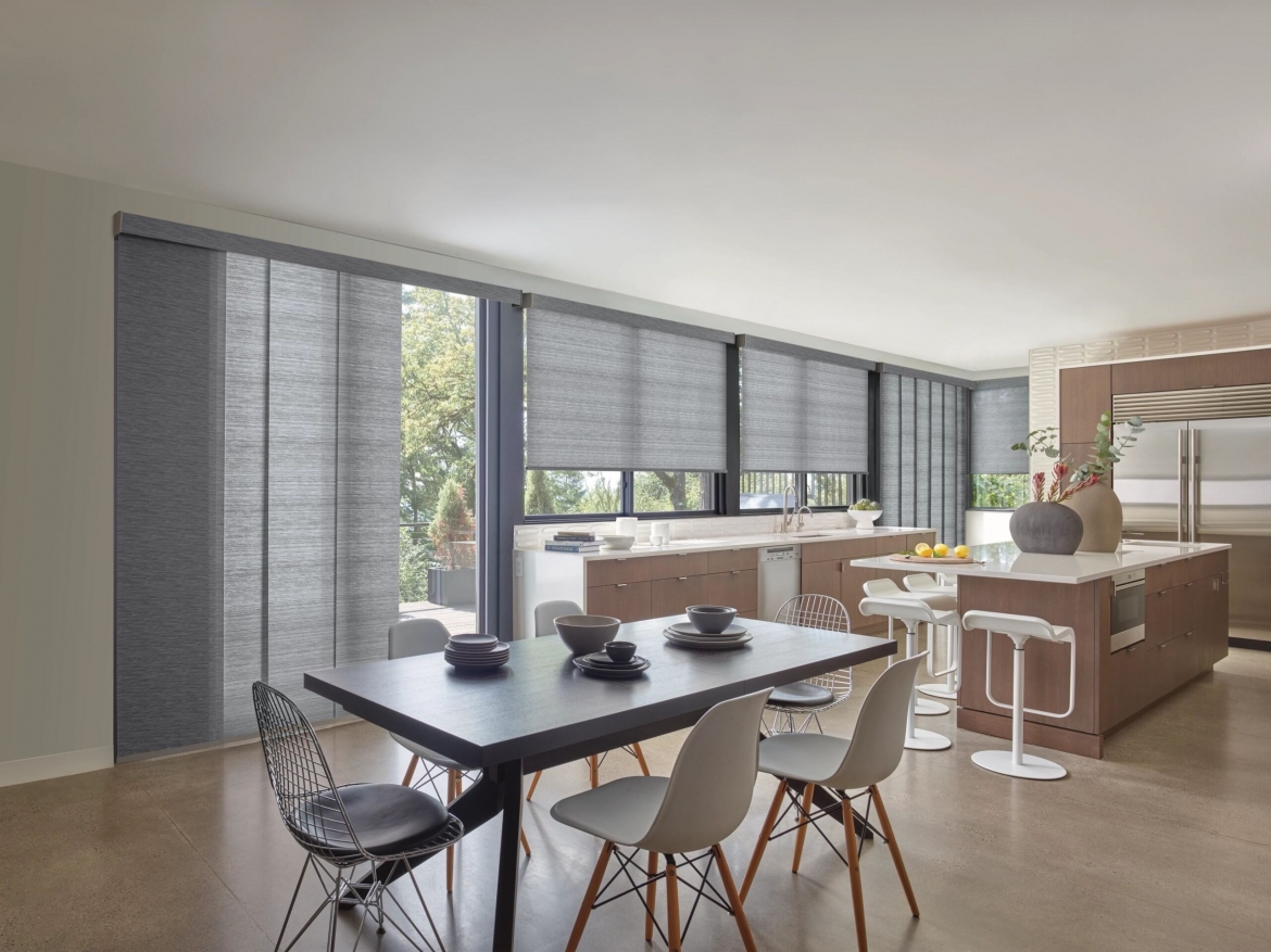 a dining room and kitchen with grey shades