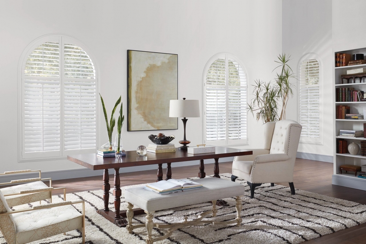 a white living room with wood shutters